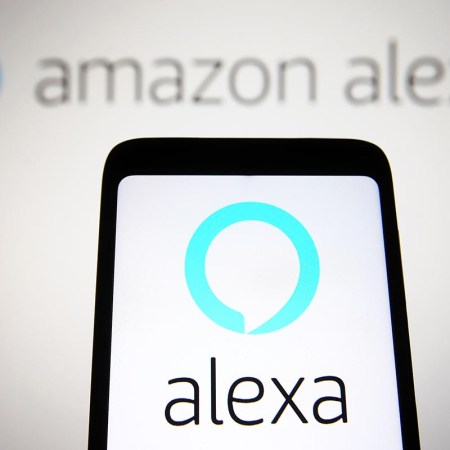 In this illustration, an Amazon Alexa logo is seen on a phone and computer screen. The voice assistant is in trouble, losing billions and leading to massive layoffs.