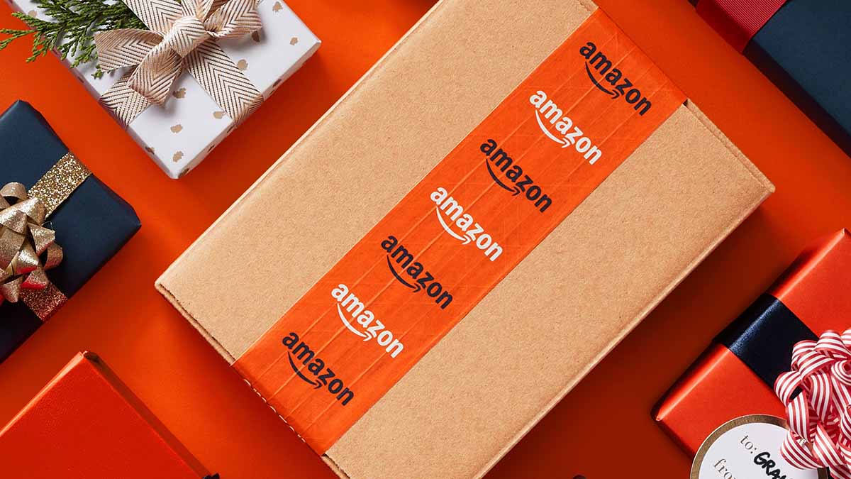 A box with Amazon tape surrounded by other wrapped gifts on a table. Amazon just announced its Black Friday deals, beginning Nov. 24