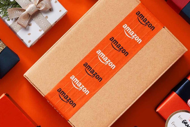A box with Amazon tape surrounded by other wrapped gifts on a table. Amazon just announced its Black Friday deals, beginning Nov. 24