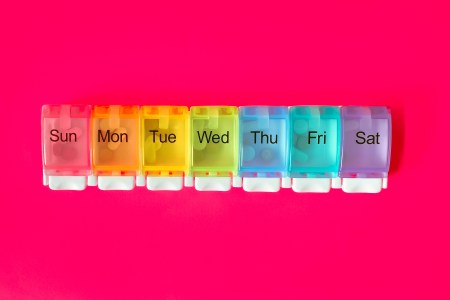 Days of the week pills against a pink background.