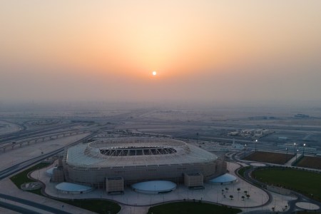 A view of Qatar's new World Cup stadiums as the sun sets in the background.