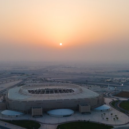 A view of Qatar's new World Cup stadiums as the sun sets in the background.