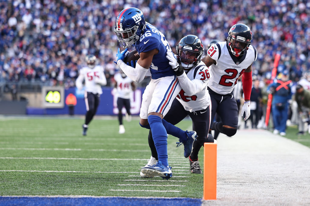 Darius Slayton of the New York Giants scores a touchdown during the third quarter while defended by Jonathan Owens of the Houston Texans at MetLife Stadium.