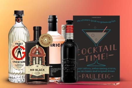 Various bottles and cocktail books for InsideHook's boozy gift guide for 2022