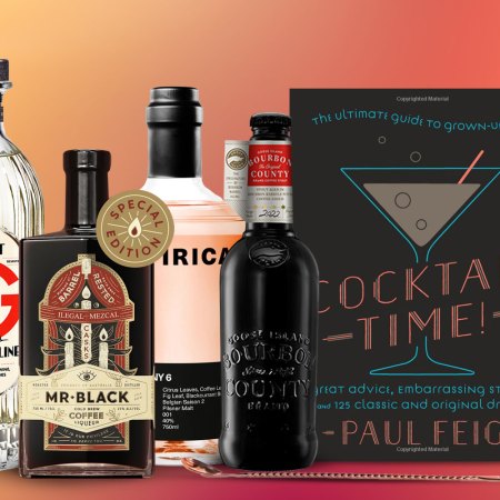 Various bottles and cocktail books for InsideHook's boozy gift guide for 2022