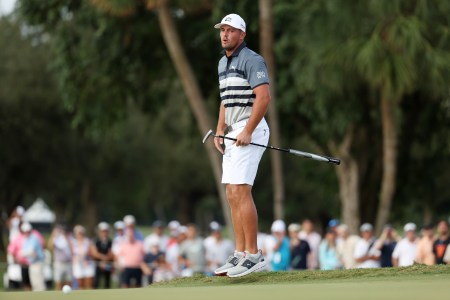 A noticeably thinner Bryson DeChambeau is seen on a putting green.