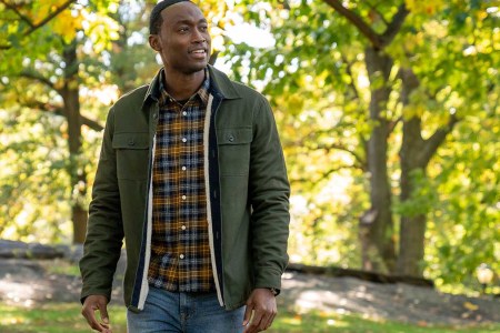 A man wearing various Jachs NY clothing (jacket, shirt, jeans) standing outside in a brightly-lit forest. JACHS NY is currently throwing a Black Friday sale.