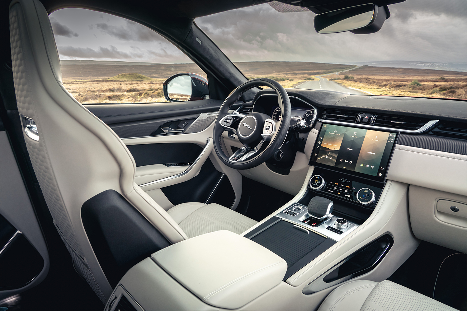 The front seats and dashboard inside the new Jaguar F-Pace SVR SUV, which features a refreshed infotainment screen