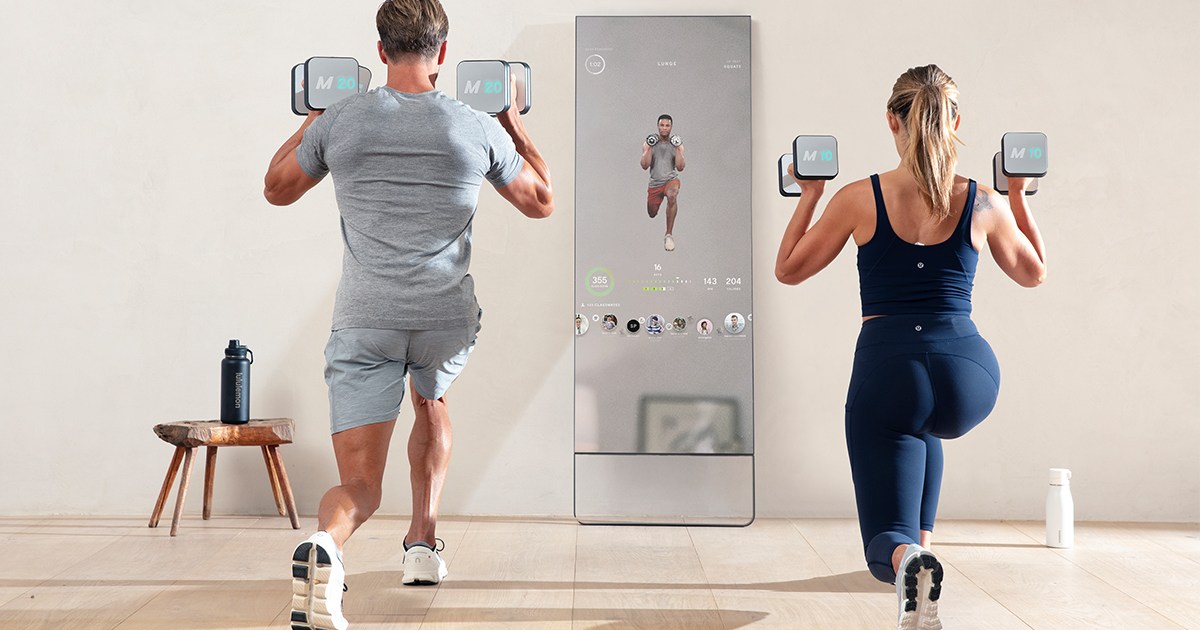 A man and woman working out with the Lululemon Studio Mirror, which is currently 50% off for Black Friday 2022