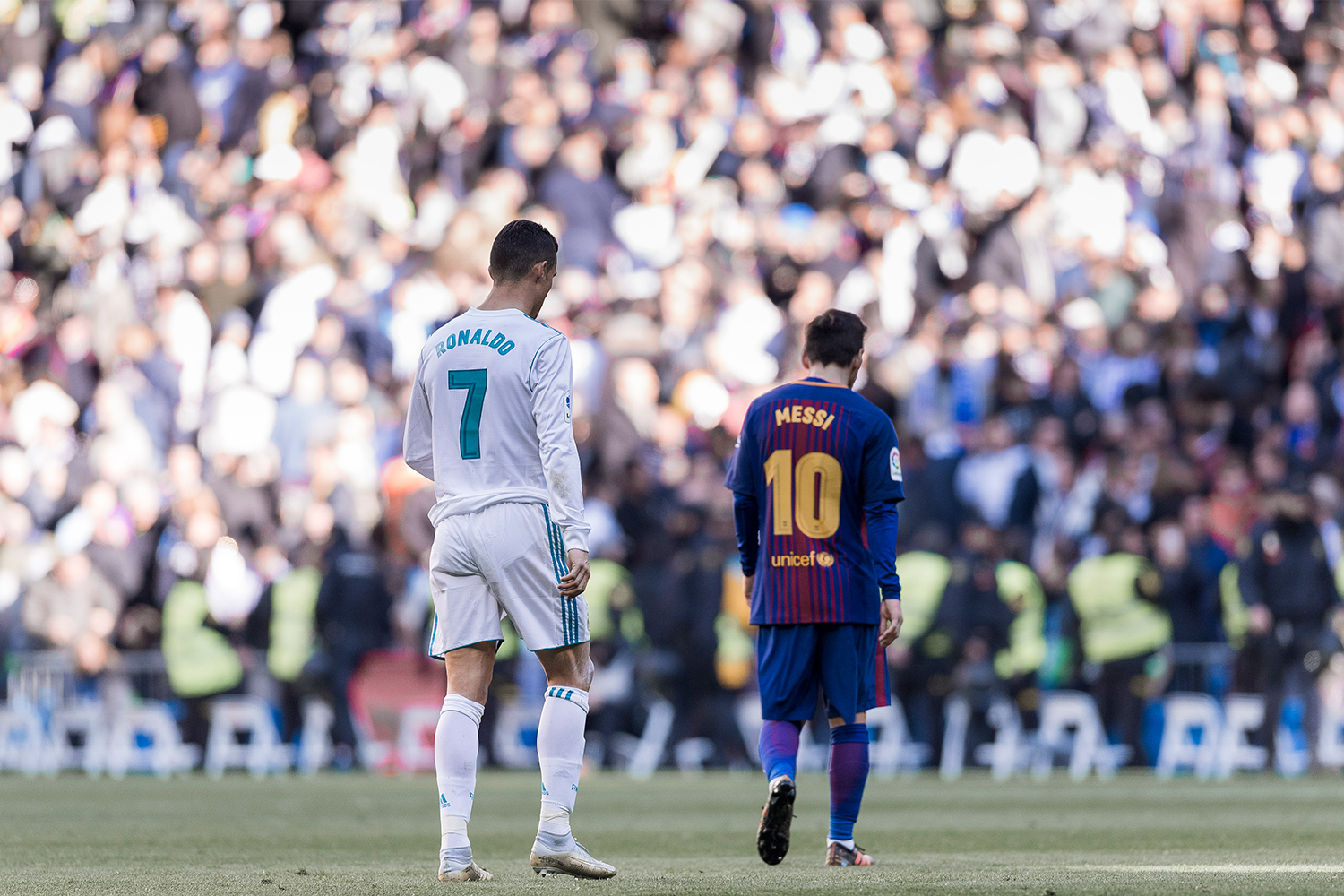Lionel Messi of FC Barcelona and Cristiano Ronaldo of Real Madrid walk off pitch during La Liga match between Real Madrid and FC Barcelona at Santiago Bernabeu stadium on December 23, 2017 in Madrid, Spain.