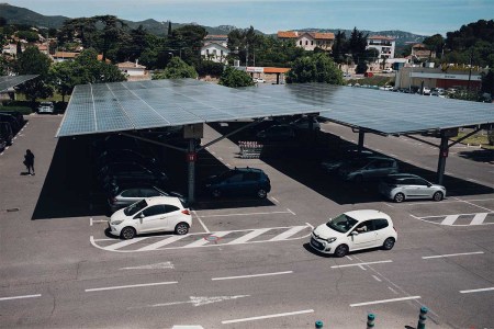 Automobiles under solar canopies at a GreenYellow renewable energy site in the parking lot of a Geant Casino hypermarket, operated by Casino Guichard Perrachon SA, in Marseille, France, on Thursday, May 20, 2021. New legislation means that large car parks in France will be required to be covered by solar panels.