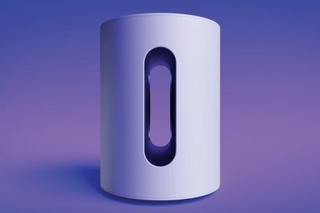 A white Sonos Sub Mini on a purple background. The mini is a new compact subwoofer.