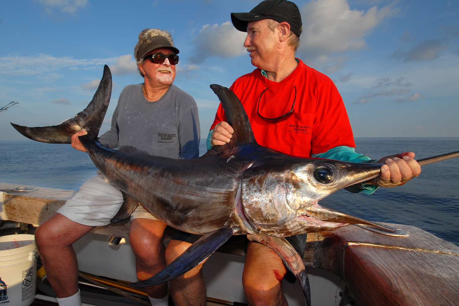 Richard Stanczyk, left, owner of Bud N' Mary's Marina in Islamorada, Fla., holds a swordfish caught during daylight hours by Vic Gaspeny, right, while fishing off Islamorada in the Florida Keys on the Catch 22. Stanczyk and Gaspeny pioneered daytime swordfishing off the Florida Keys.