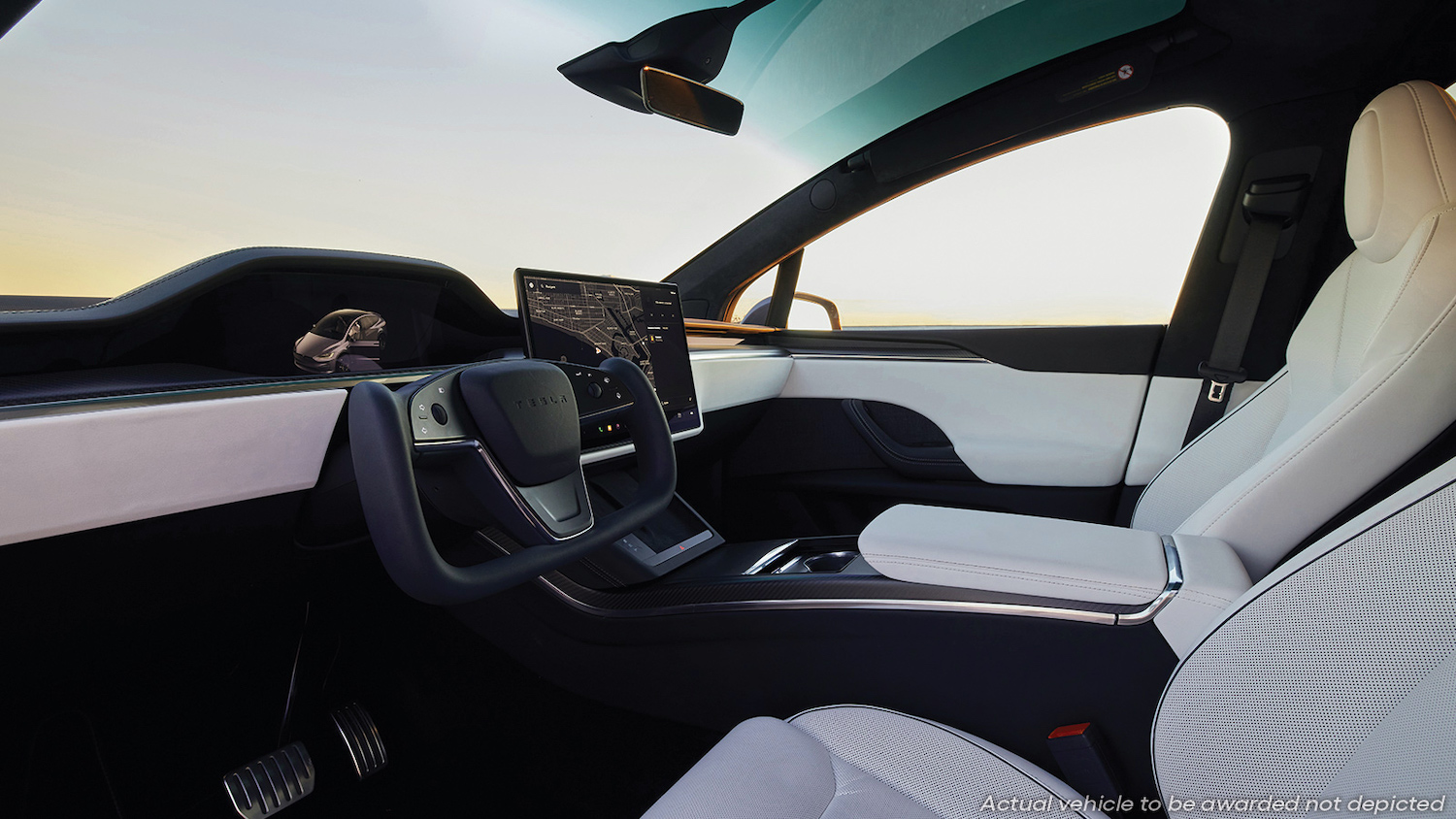 The interior of a Tesla Model X Plaid, with a yoke steering wheel and large infotainment screen