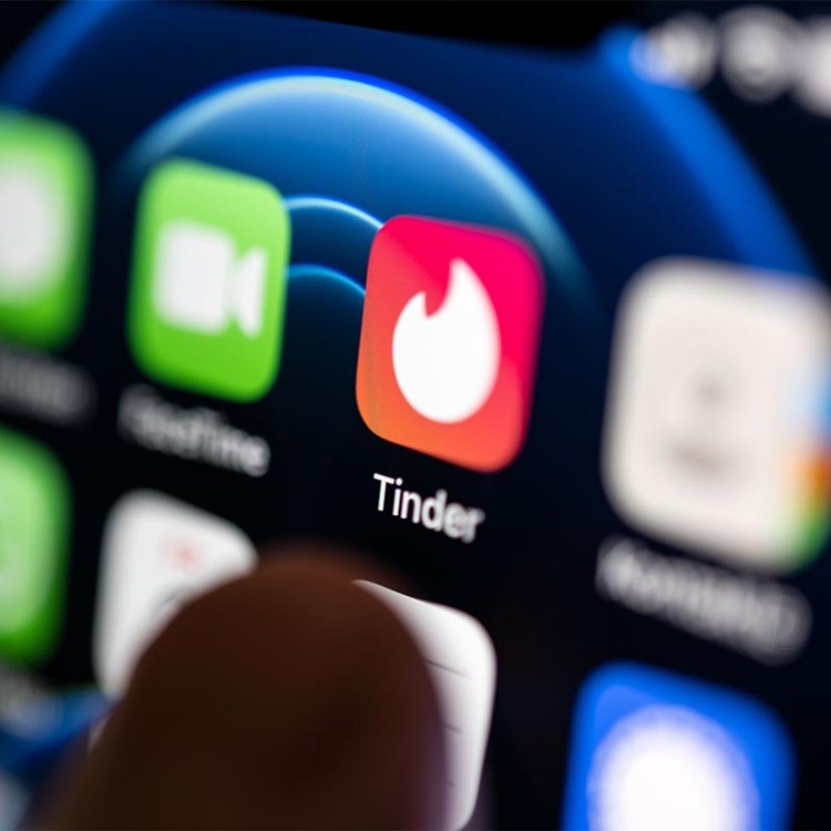 A hand taps on the Tinder app installed on a smartphone. The dating app launched on September 12, ten years ago. The app's "Year in Swipe" report was just released