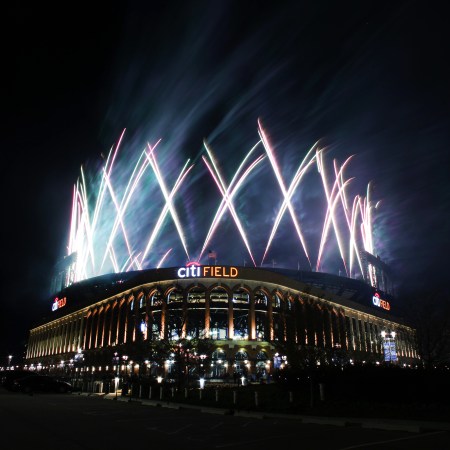 Citi Field, the home of the New York Mets, at night with fireworks shooting into the sky
