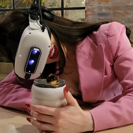 A woman eating a meal with a Meta Quest 2 VR headset at Aerobanquets in Brooklyn, New York in 2022