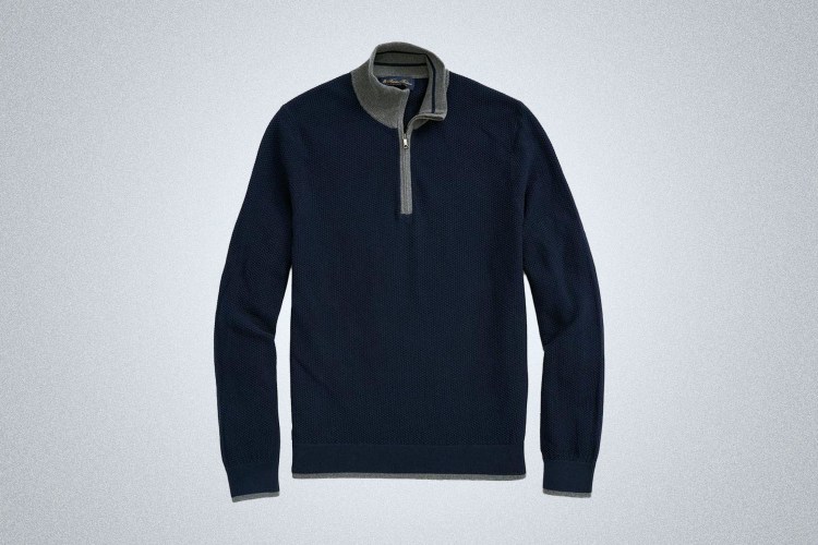 a blue and grey Brooks Brothers sweater on a grey background