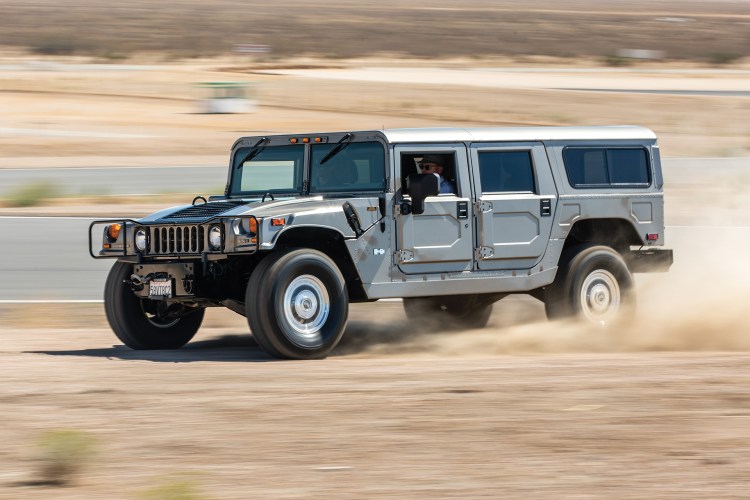 A Hummer H1, which is included in Hagerty's Bull Market List as a collector car to watch in 2023, rips around in the desert