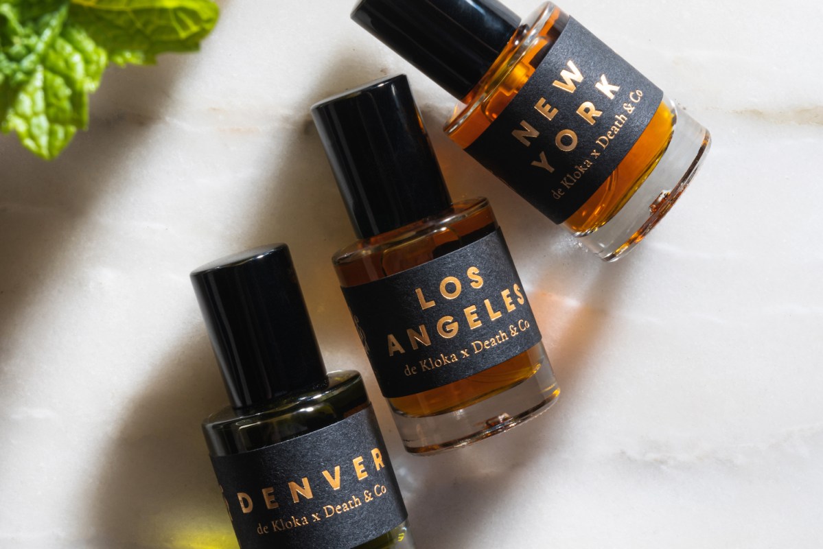 three fragrances from death & co on a marble background