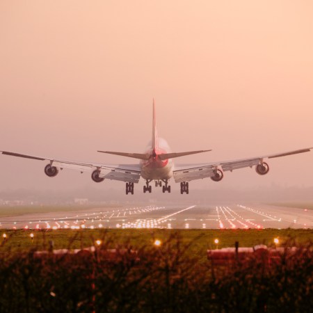 Boeing 747 airplane Landing into sunset