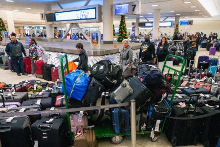 Travelers surrounded by luggage in Chicago on Monday