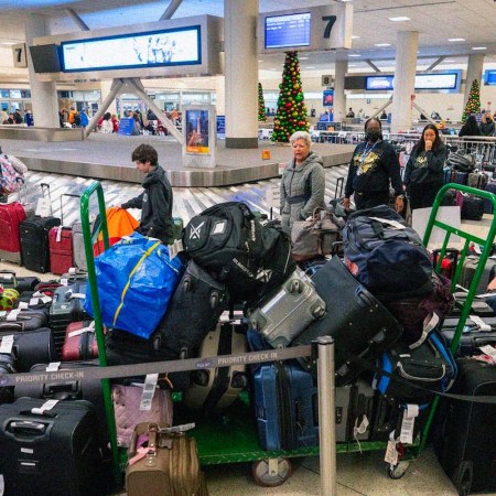 Travelers surrounded by luggage in Chicago on Monday
