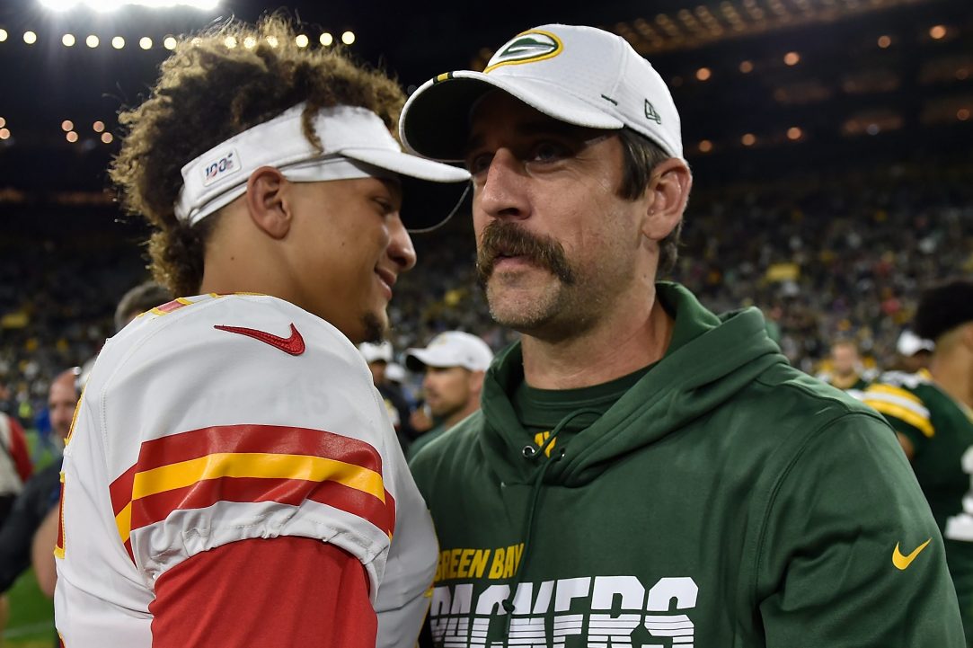 Aaron Rodgers shakes hands with Patrick Mahomes after a preseason game.