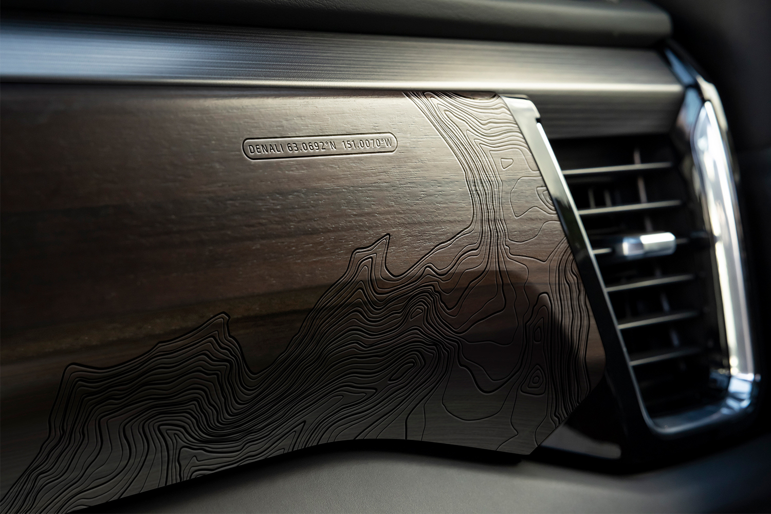 Topographical lines and GPS coordinates for Denali engraved into the wood dashboard of the GMC Sierra Denali Ultimate