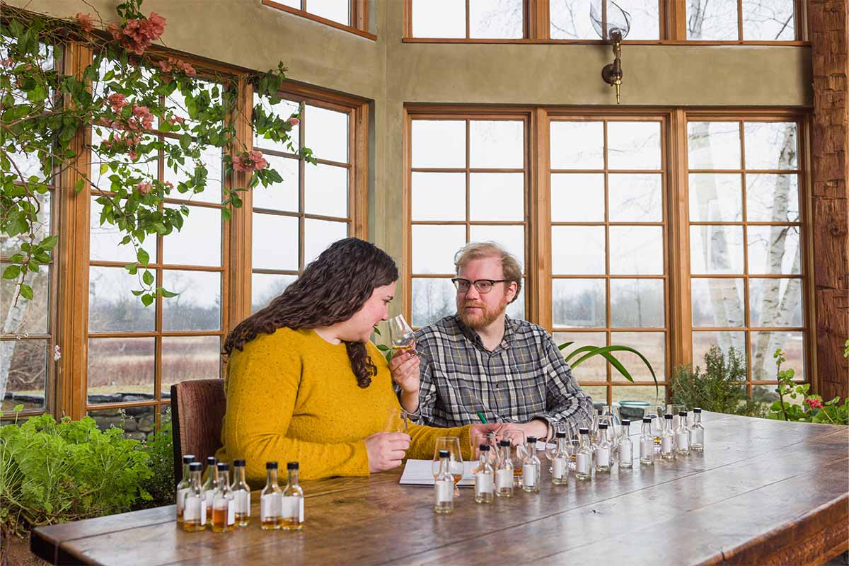 Lost Lantern founders Nora Ganley-Roper and Adam Polonski, sampling whiskey at a table