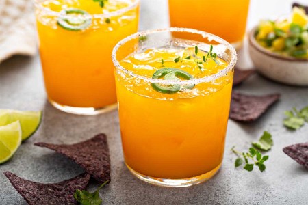 Spicy pineapple and mango refreshing margarita with chips and salsa. According to a new report by Bacardi, we'll be drinking a lot of spicy margaritas in 2023.