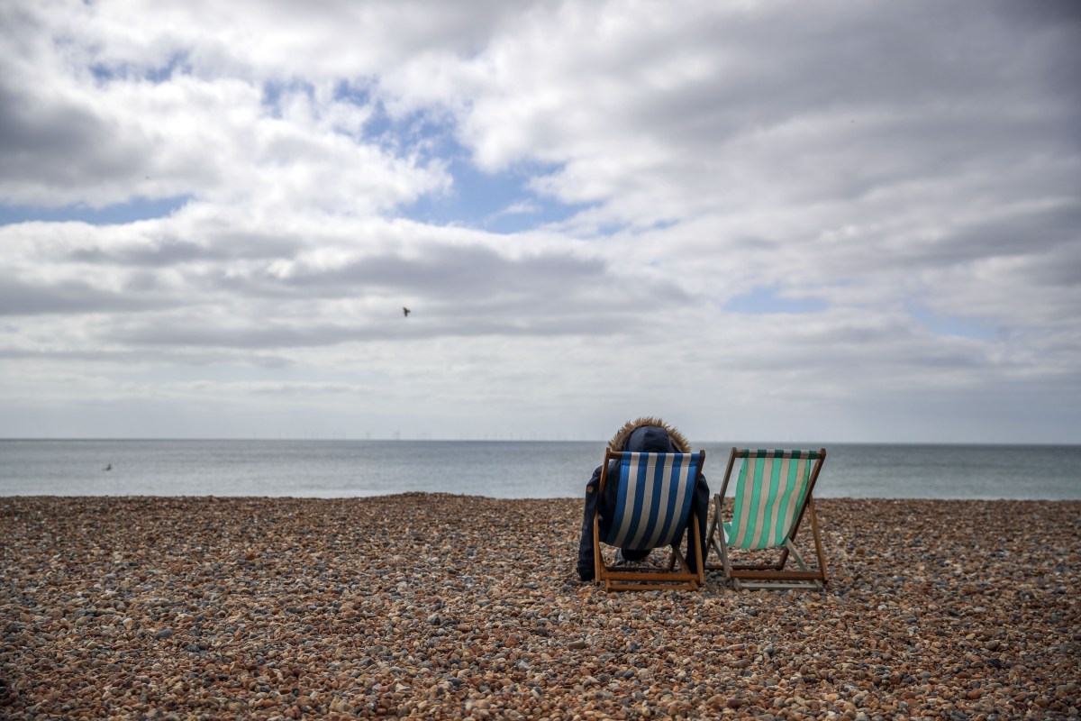 A man sitting alone on the beach.