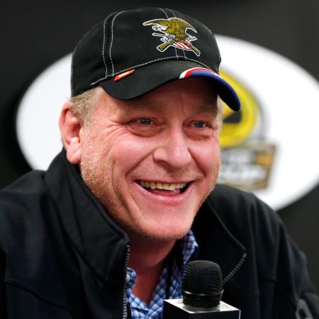 Ex-MLB player Curt Schilling speaks with the media before a NASCAR race.