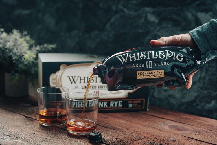 WhistlePig 10 Limited Edition PiggyBank being poured on a table. The uniquely shaped decanter means you're literally pouring from the pig's rear.