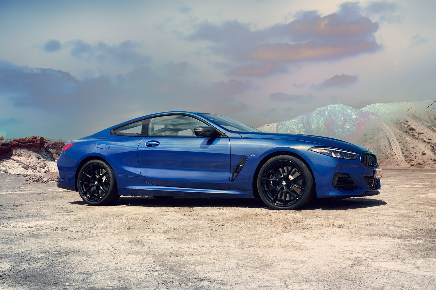The side profile of a blue 2023 BMW M850i Coupe, a luxury coupe that's part of the 8 Series models