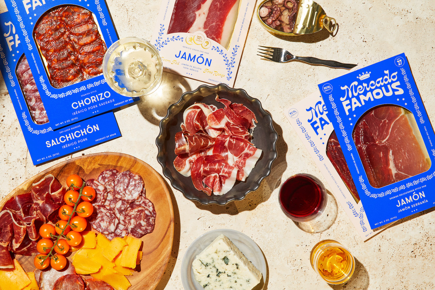 packs of mercado famous cured meat on a table with wine, cheese and tinned octopus