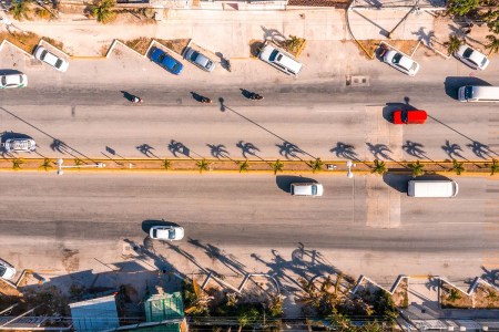 Aerial view of cars driving down a road in Cancún