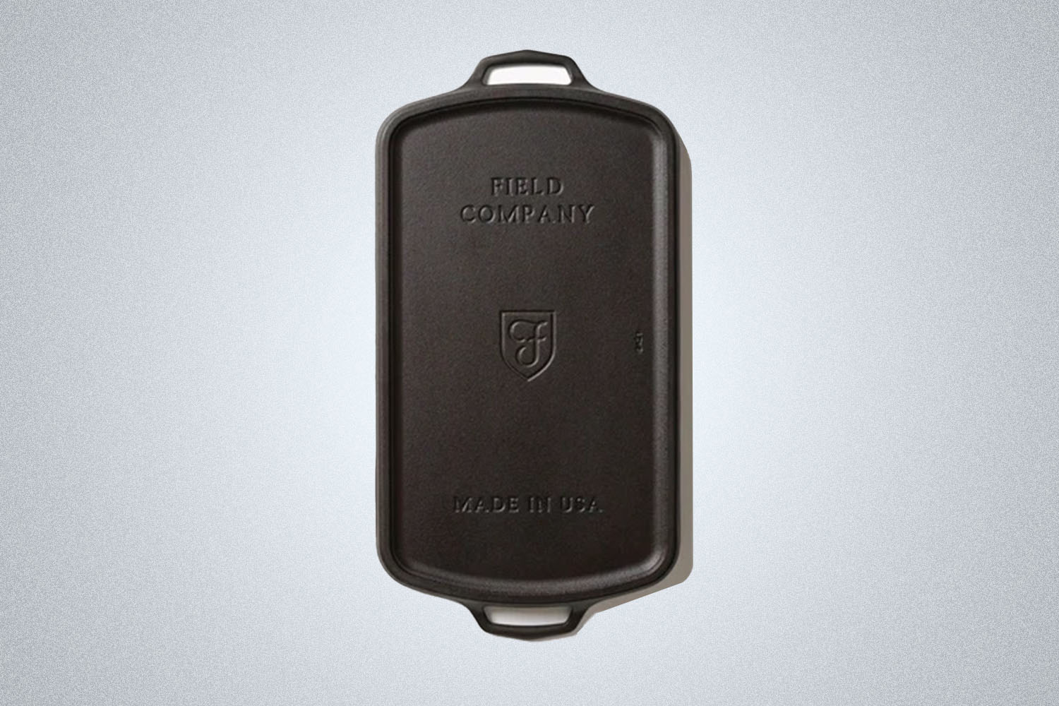 a Field Company Cast Iron Griddle on a grey background