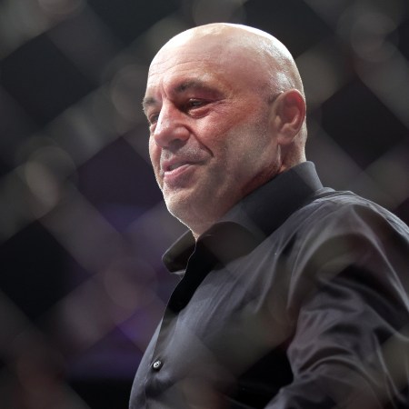 Joe Rogan walks inside the Octagon during the UFC 282 event at T-Mobile Arena on December 10, 2022 in Las Vegas, Nevada.