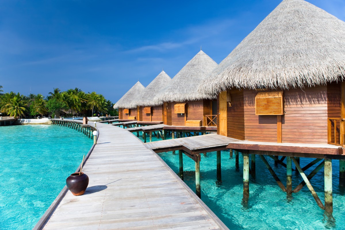 overwater villas with a walkway at a maldives hotel