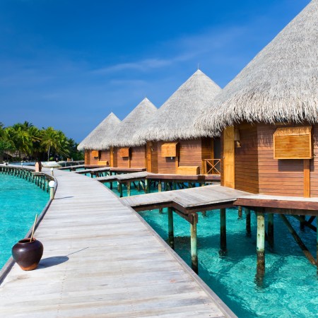 overwater villas with a walkway at a maldives hotel