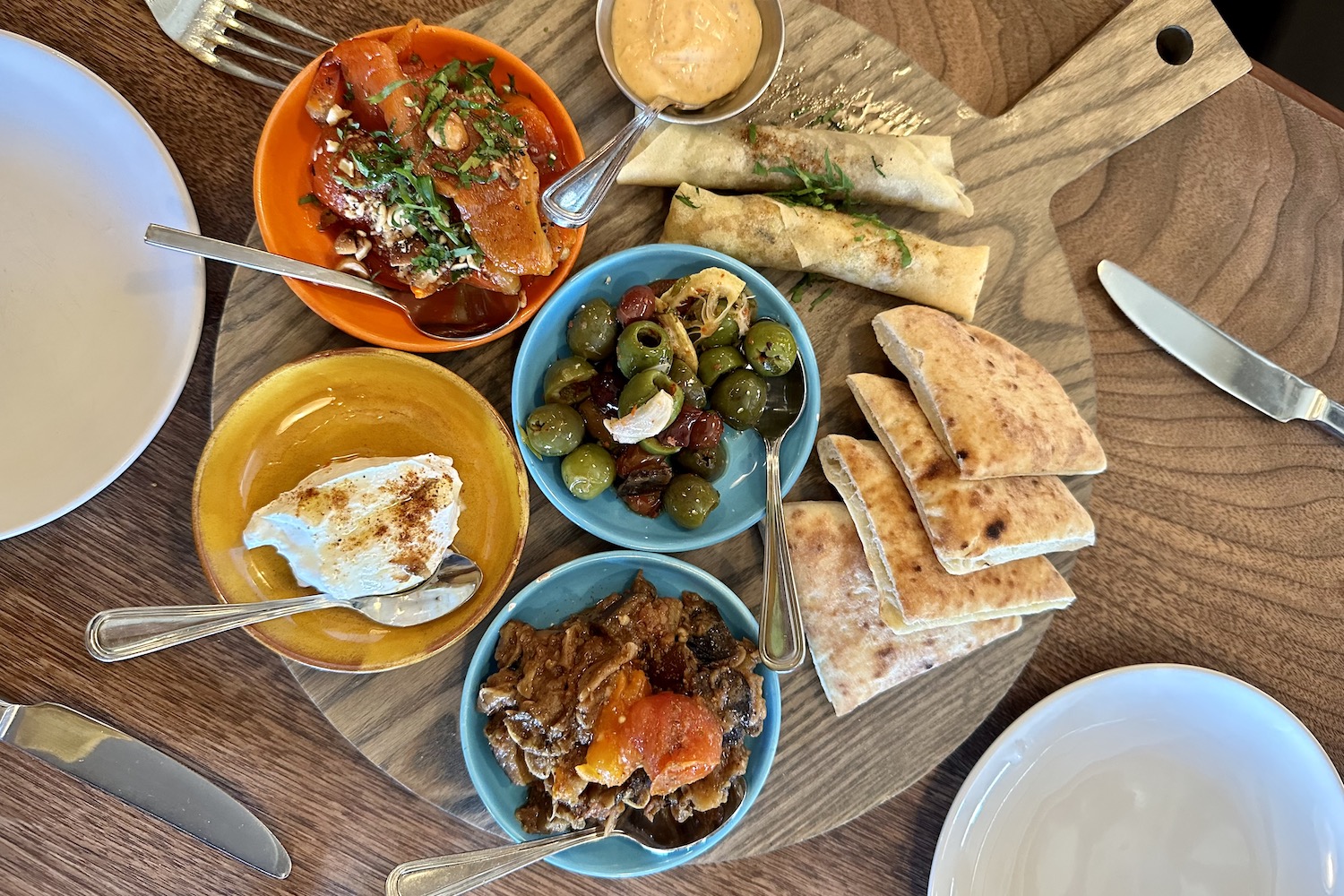 mezze platter with olives, labneh, eggplant, moroccan cigars and pita