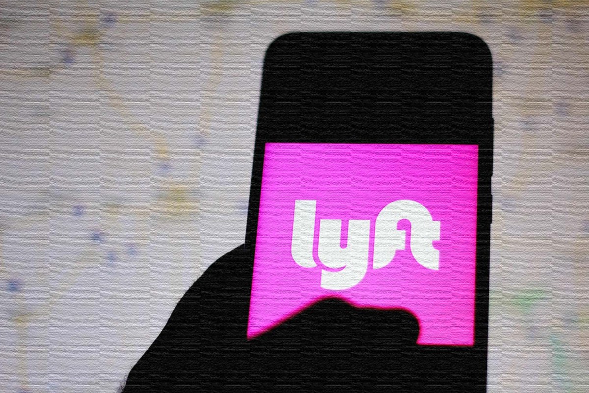 The Lyft logo is seen displayed on a smartphone.