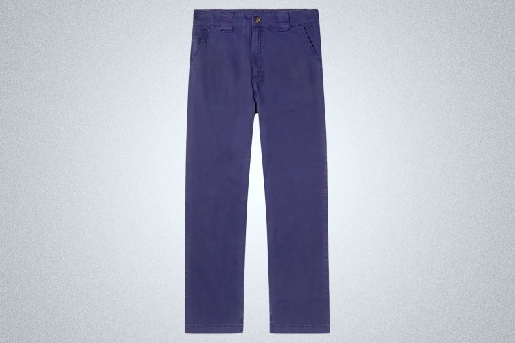 a pair of navy chinos on a grey background
