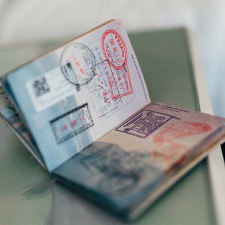 A passport open on a table. What's the most powerful passport for 2023? The ranking was just released.