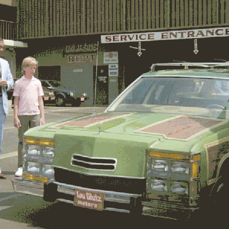 A scene from "National Lampoon's Vacation" with Clark Griswold standing next to the Family Truckster station wagon, which morphs into a Toyota RAV4 SUV