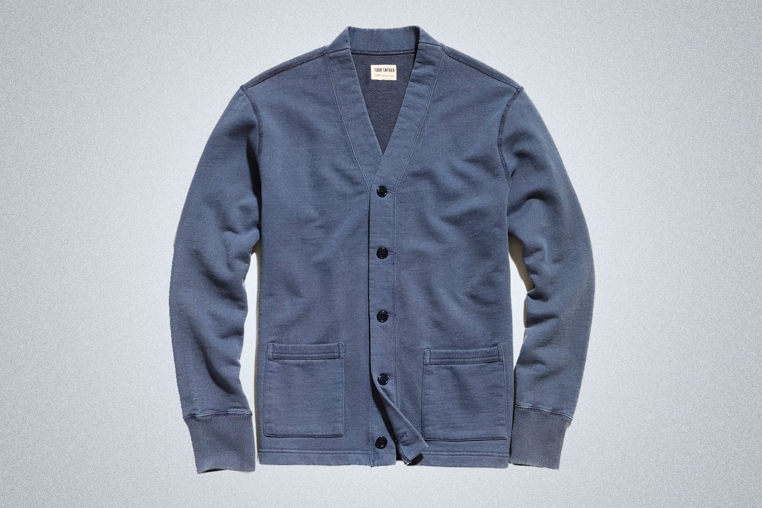 a navy Todd Snyder cardigan on a grey background