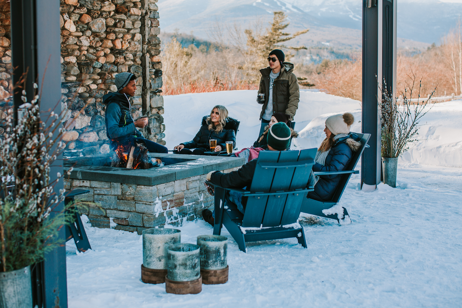 people sitting around the fire pit at Topnotch Resort Stowe