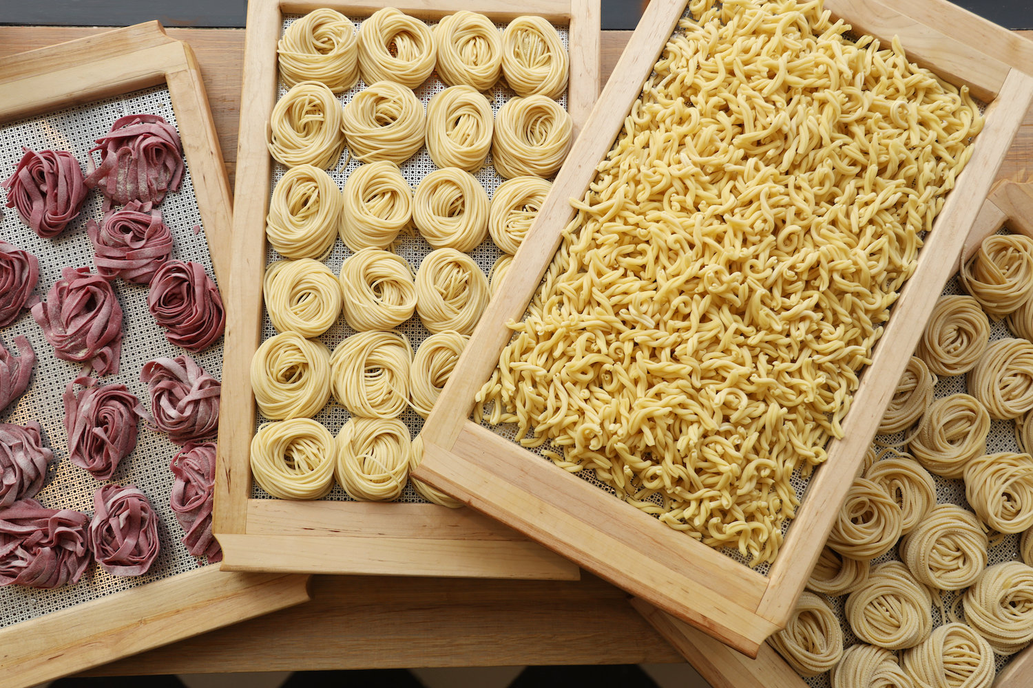 Freshly made pastas displayed on trays