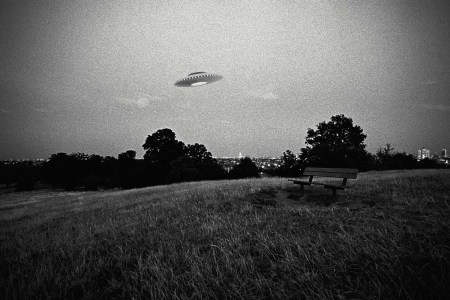 UFO in flight above urban park